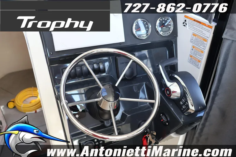 Slide: The Image of 2026 Bayliner Trophy T25 Pilothouse helm with steering wheel and controls. - 27