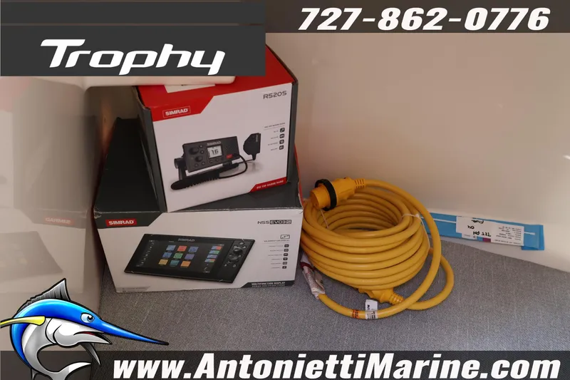 Slide: The Image of Bayliner Trophy T25 Pilothouse 2026 with Simrad electronics and coiled yellow cable. - 37