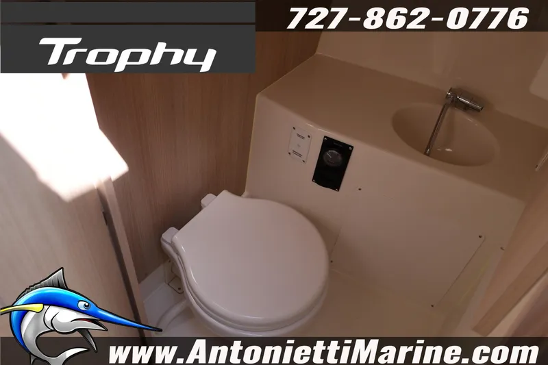Slide: The Image of 2026 Bayliner Trophy T25 Pilothouse bathroom interior with sink and toilet. - 38