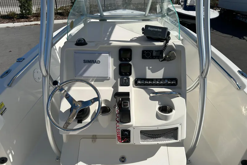 Slide: The Image of 2015 Sailfish 220 CC boat console with Simrad and Raymarine electronics. - 11