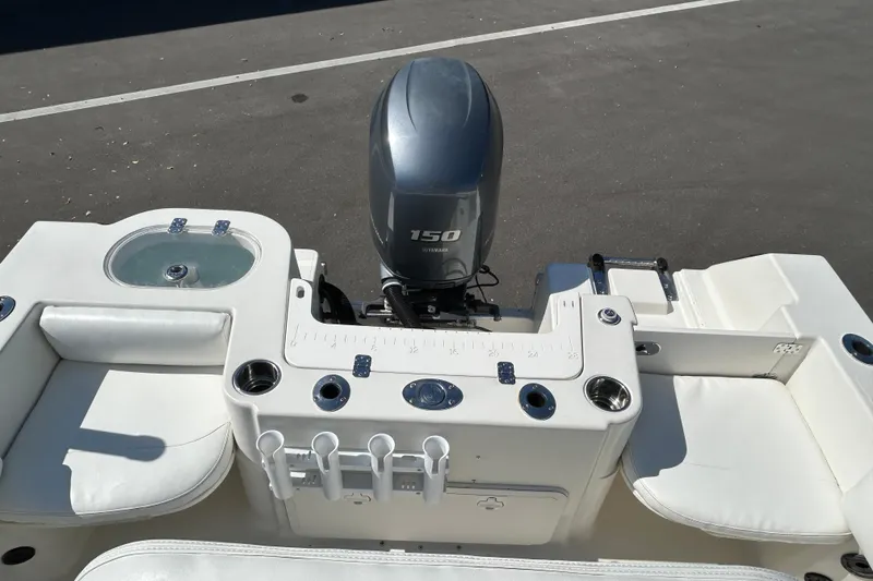 Slide: The Image of 2015 Sailfish 220 CC boat with Yamaha 150 engine, featuring fishing rod holders and seating. - 13
