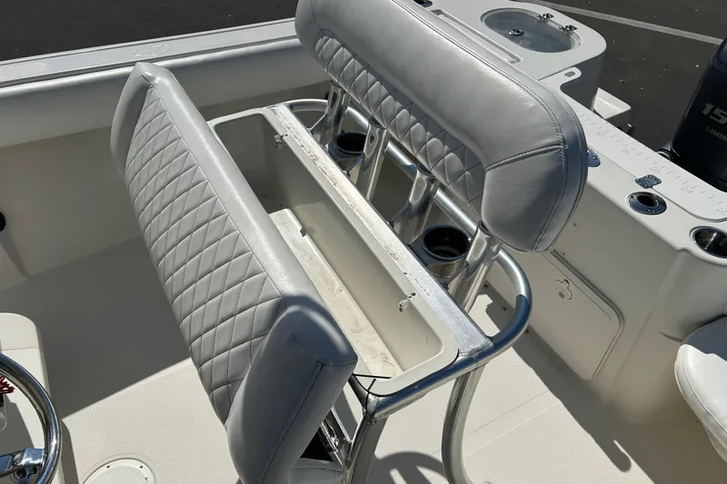 Slide: The Image of 2015 Sailfish 220 CC boat interior with cushioned seating and rod holders. - 16