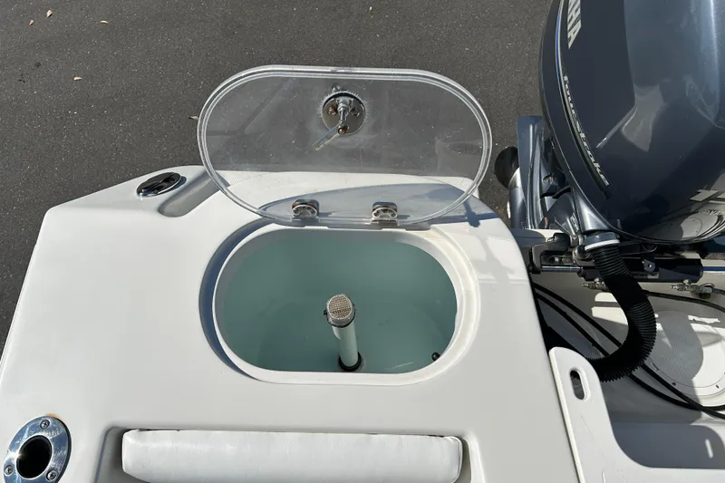 Slide: The Image of 2015 Sailfish 220 CC boat livewell and Yamaha outboard motor. - 17
