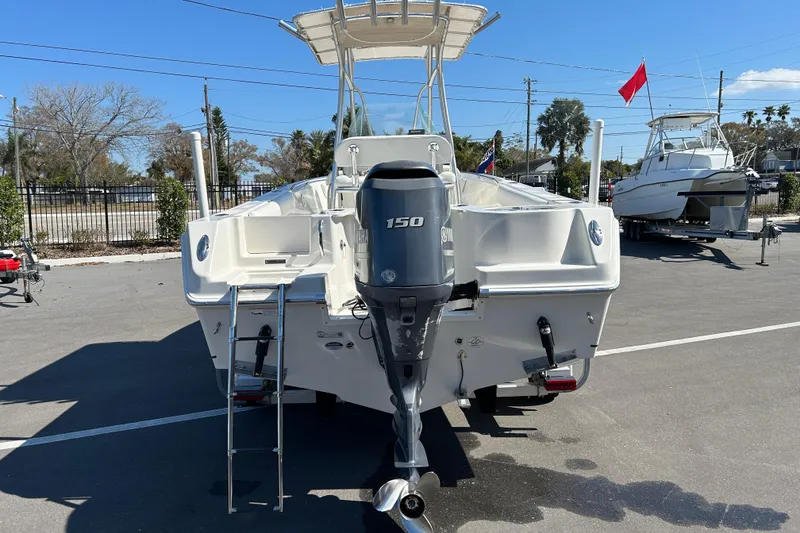 Slide: The Image of 2015 Sailfish 220 CC boat with Yamaha 150 engine, parked outdoors. - 3