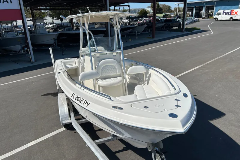 Slide: The Image of 2015 Sailfish 220 CC boat on trailer in a parking lot, front view. - 6