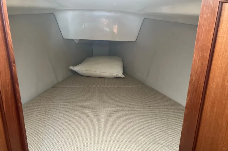 Slide: The Image of Cozy cabin interior of 1995 Hunter Legend 35.5 sailboat with pillow on bed. - 10