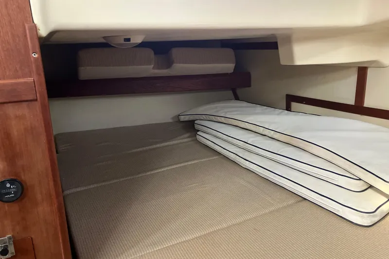 Slide: The Image of Cozy cabin interior of 1995 Hunter Legend 35.5 sailboat with stacked cushions. - 12