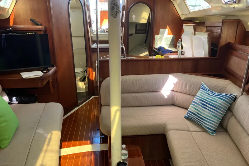 Slide: The Image of Interior of 1995 Hunter Legend 35.5 sailboat with cozy seating and wooden finishes. - 13