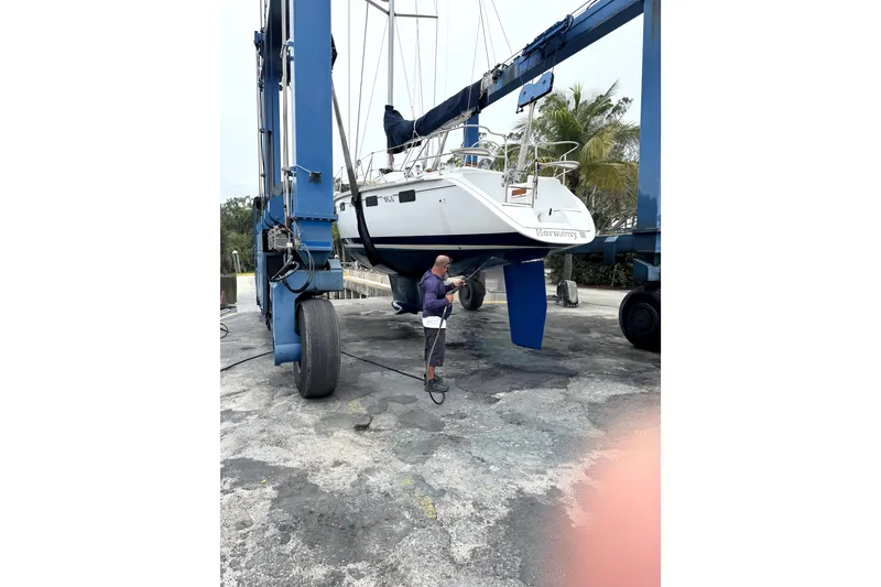 Slide: The Image of Sailboat Hunter Legend 35.5, 1995 model, lifted by crane for maintenance. - 16