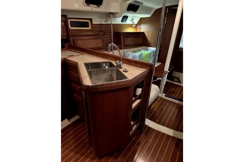 Slide: The Image of Interior of 1995 Hunter Legend 35.5 sailboat with wooden cabinetry and sink. - 4