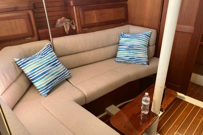 Slide: The Image of Cozy interior of 1995 Hunter Legend 35.5 sailboat with striped cushions and wooden accents. - 9