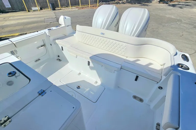 Slide: The Image of 2026 Sea Hunt Ultra 285 SE boat interior with white seating and dual engines. - 12