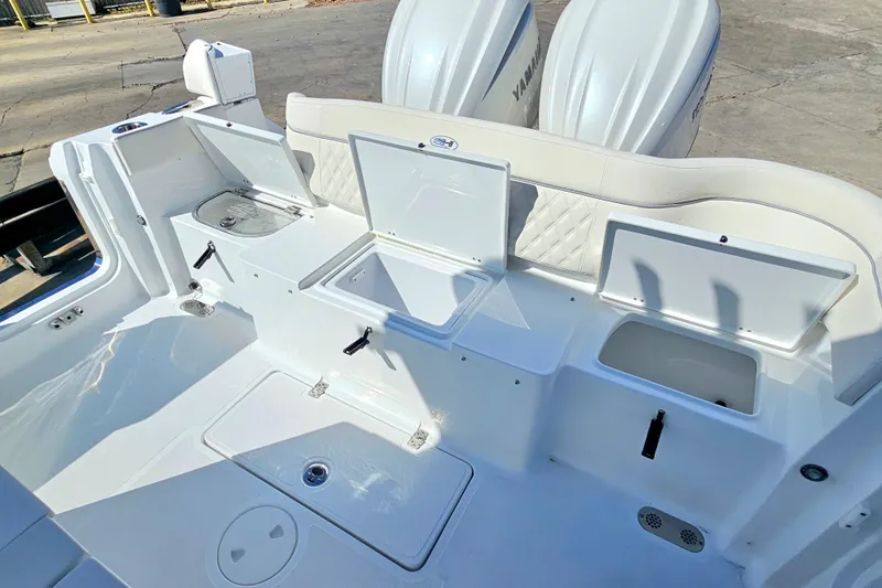 Slide: The Image of 2026 Sea Hunt Ultra 285 SE boat interior with storage compartments and Yamaha engines. - 13