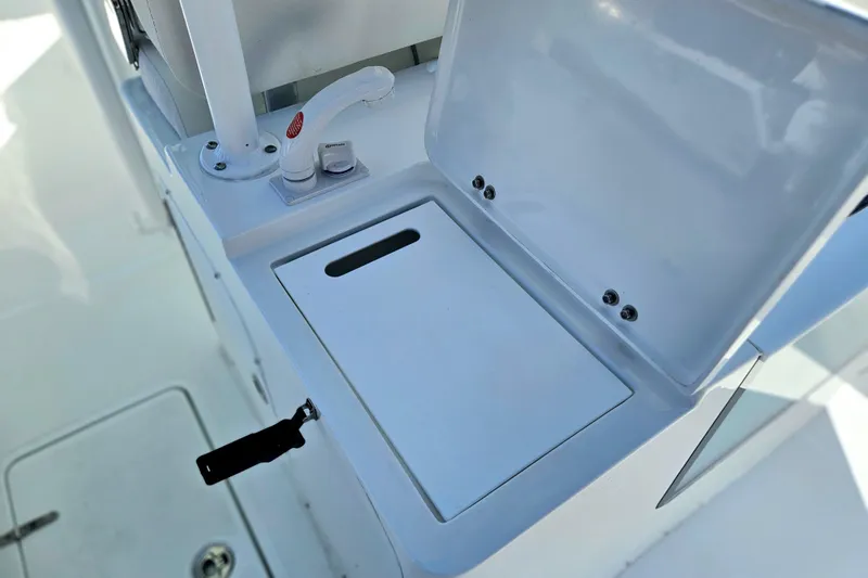 Slide: The Image of 2026 Sea Hunt Ultra 285 SE boat compartment with open lid and faucet. - 17