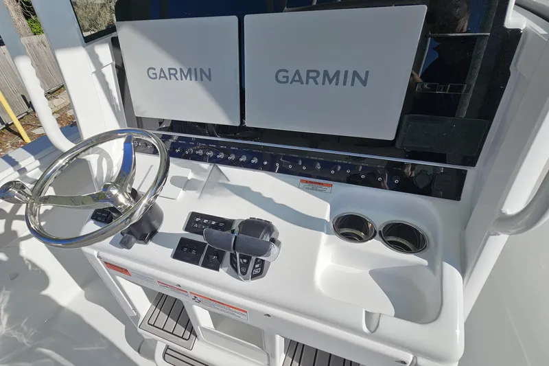 Slide: The Image of 2026 Sea Hunt Ultra 285 SE helm with dual Garmin displays and steering wheel. - 21