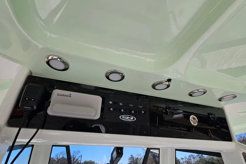 Slide: The Image of 2026 Sea Hunt Ultra 285 SE boat dashboard with Garmin electronics and overhead lighting. - 23