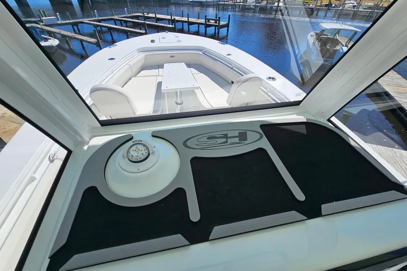 Slide: The Image of 2026 Sea Hunt Ultra 285 SE boat interior with compass and seating area. - 24