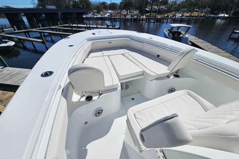 Slide: The Image of 2026 Sea Hunt Ultra 285 SE boat with luxurious seating at a marina dock. - 27