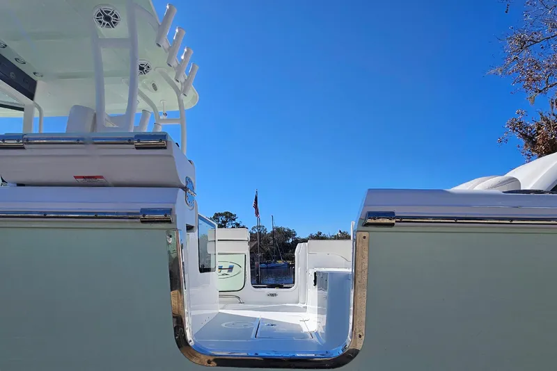 Slide: The Image of 2026 Sea Hunt Ultra 285 SE boat, sleek design, clear blue sky background. - 3