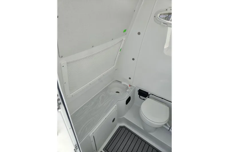Slide: The Image of Interior of 2026 Sea Hunt Ultra 285 SE boat bathroom with toilet and sink. - 30
