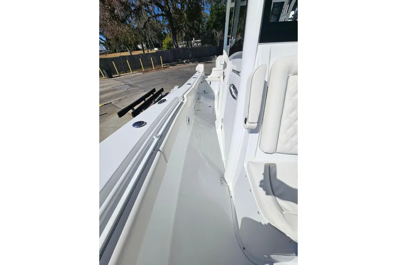 Slide: The Image of 2026 Sea Hunt Ultra 285 SE boat deck with white seating and sleek design. - 32