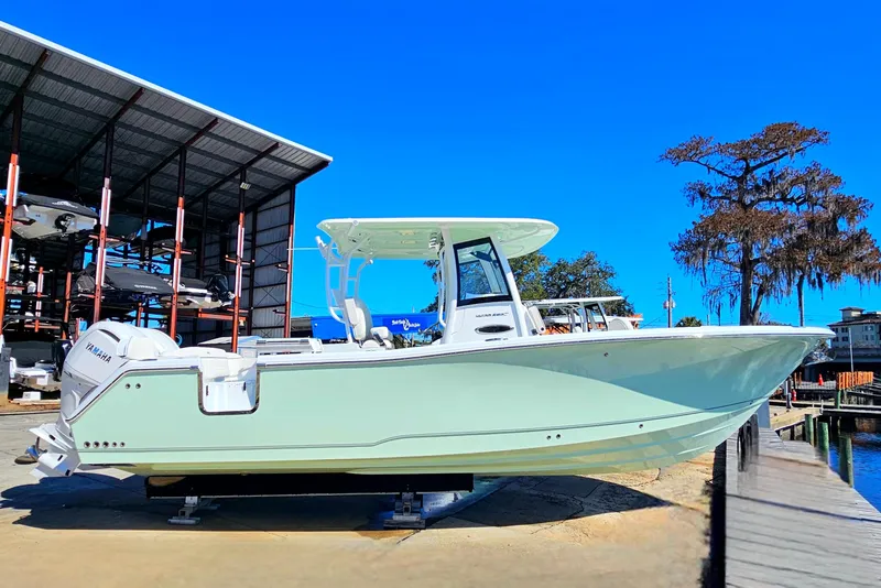 Slide: The Image of 2026 Sea Hunt Ultra 285 SE boat docked, featuring sleek design and Yamaha engine. - 7