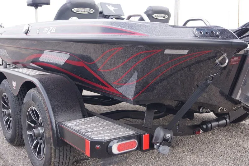 Slide: The Image of 2026 Phoenix 721 ZXL boat on trailer with sleek black and red design. - 10