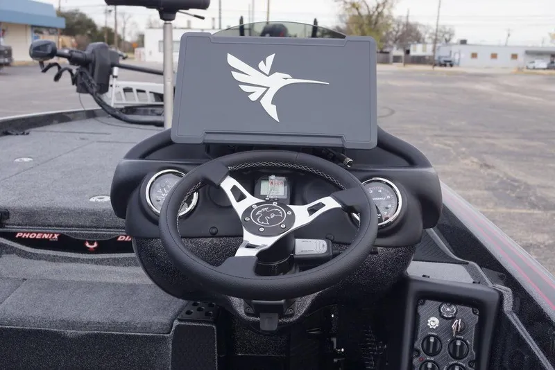 Slide: The Image of 2026 Phoenix 721 ZXL boat dashboard with steering wheel and control panel. - 14