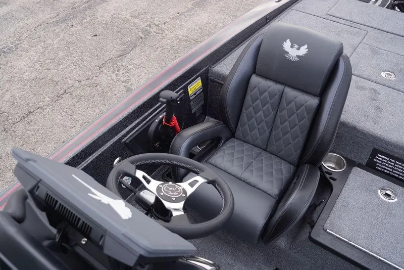 Slide: The Image of 2026 Phoenix 721 ZXL boat interior with steering wheel and quilted seat design. - 18