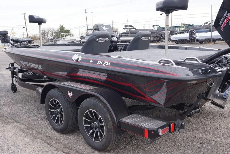 Slide: The Image of 2026 Phoenix 721 ZXL bass boat with sleek design and dual-axle trailer. - 9