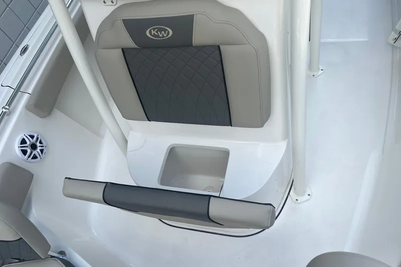 Slide: The Image of 2026 Key West 219 FS boat interior with cushioned seating and storage compartment. - 14