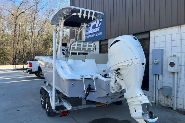 Slide: The Image of 2026 Key West 219 FS boat on trailer, parked outdoors near building. - 2