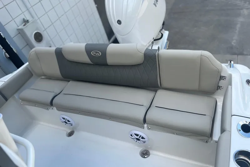 Slide: The Image of 2026 Key West 219 FS boat with cushioned seating and integrated speakers. - 4