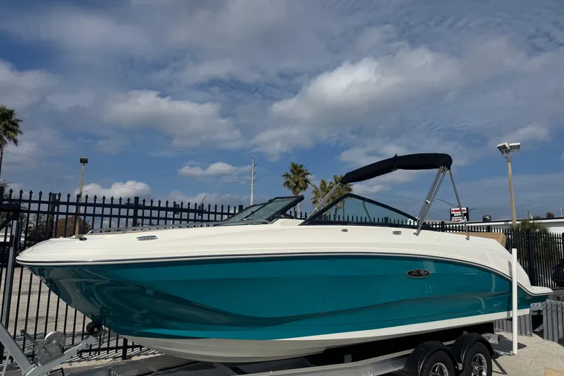 The Image of 2023 Sea Ray SDX 250 Outboard boat on trailer under cloudy sky. - 1