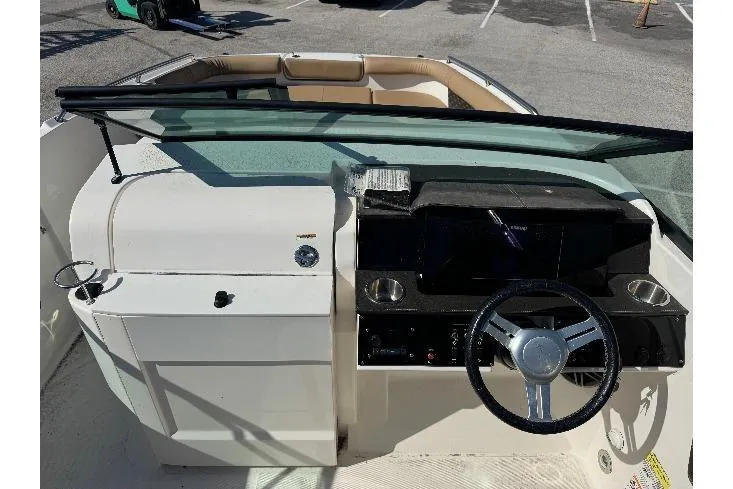 Slide: The Image of 2023 Sea Ray SDX 250 Outboard boat dashboard with steering wheel and controls. - 10
