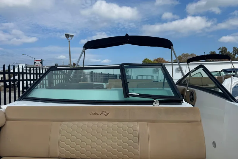 Slide: The Image of 2023 Sea Ray SDX 250 Outboard boat with tan seating and black canopy. - 12