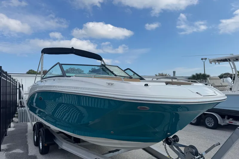 Slide: The Image of 2023 Sea Ray SDX 250 Outboard boat on trailer under blue sky. - 7