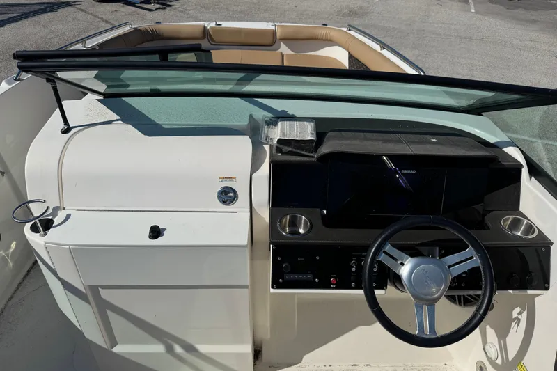 Slide: The Image of 2023 Sea Ray SDX 250 Outboard dashboard with steering wheel and controls. - 8