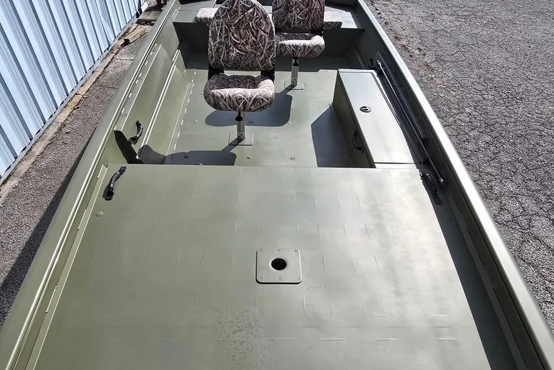 Slide: The Image of 2026 Lowe Roughneck RX1860 Tiller boat with camo seats, docked outdoors. - 2