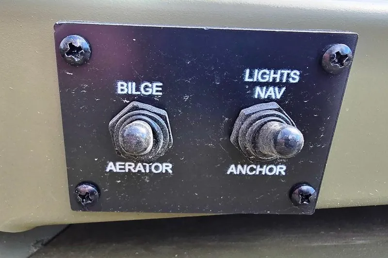 Slide: The Image of Control panel of 2026 Lowe Roughneck RX1860 Tiller with bilge and navigation switches. - 6