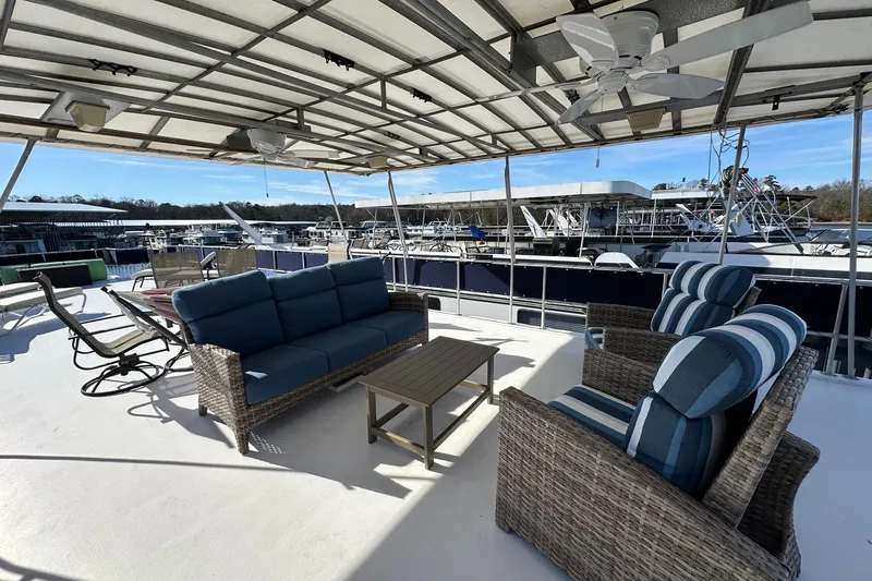 Slide: The Image of Rooftop deck of 2000 Sumerset 16x73 houseboat with wicker furniture and marina view. - 16