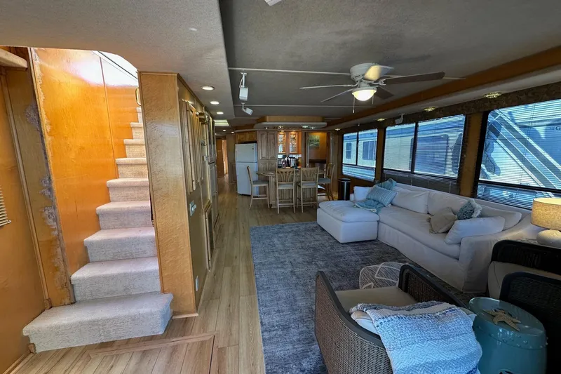 Slide: The Image of Interior of a 2000 Sumerset 16x73 houseboat with cozy living area and dining space. - 2