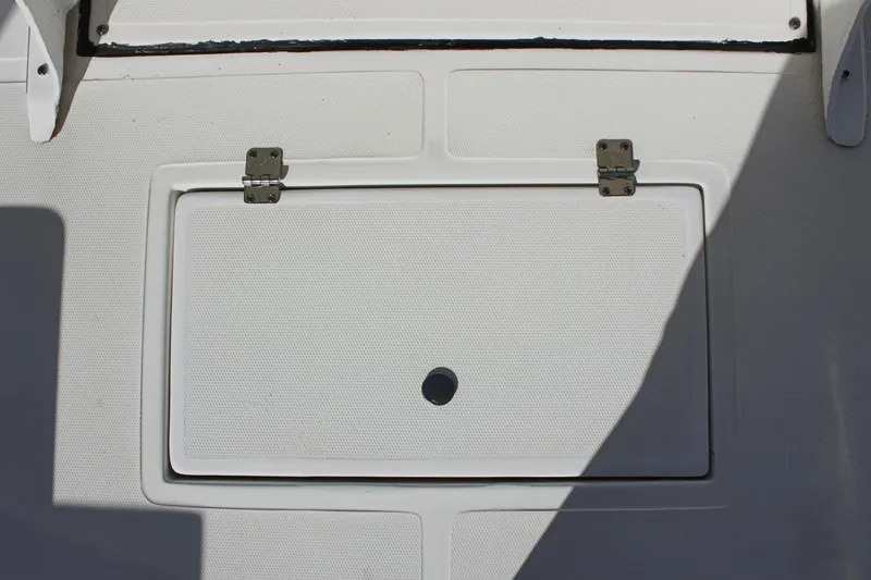 Slide: The Image of 2024 Clear Water 2000 CC boat hatch with shadow, featuring durable hinges. - 10
