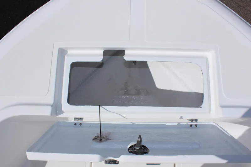 Slide: The Image of 2024 Clear Water 2000 CC boat storage compartment, open lid, white interior. - 25