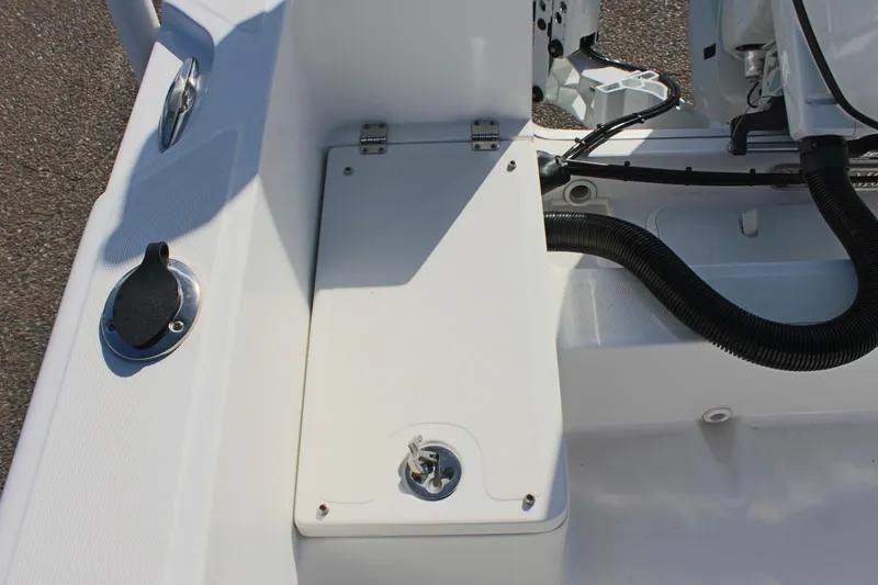 Slide: The Image of 2024 Clear Water 2000 CC boat deck with storage compartment and engine components. - 9