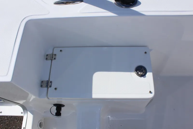 Slide: The Image of 2024 Clear Water 2000 CC boat storage compartment with white hatch and metal hinges. - 11