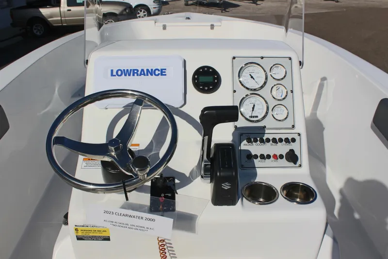 Slide: The Image of 2024 Clear Water 2000 CC boat dashboard with steering wheel and control panel. - 12