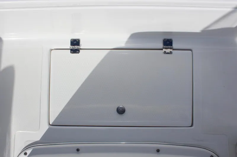Slide: The Image of 2024 Clear Water 2000 CC boat storage compartment with metal hinges and latch. - 16