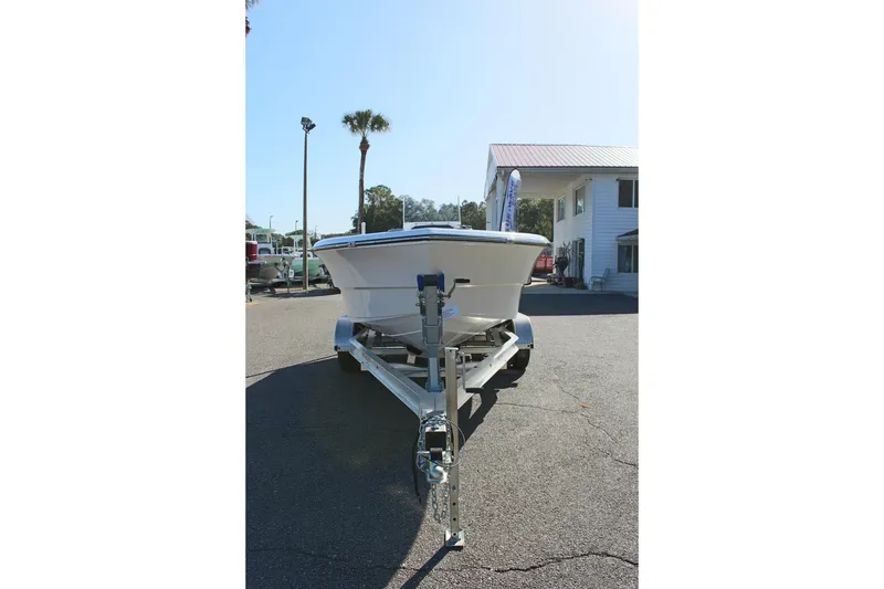 Slide: The Image of 2024 Clear Water 2000 CC boat on trailer in sunny outdoor setting. - 3