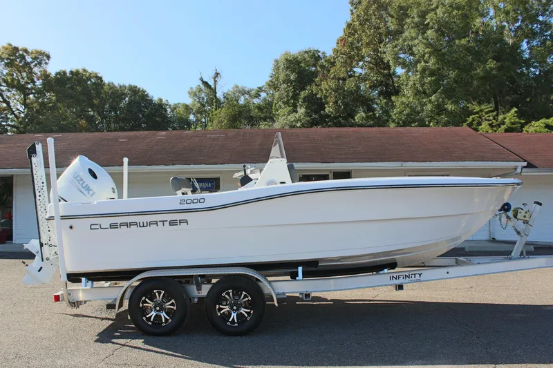 Slide: The Image of 2024 Clear Water 2000 CC boat on trailer, parked outdoors. - 5